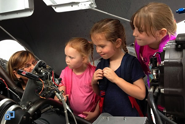 Three young ladies getting a closer look.